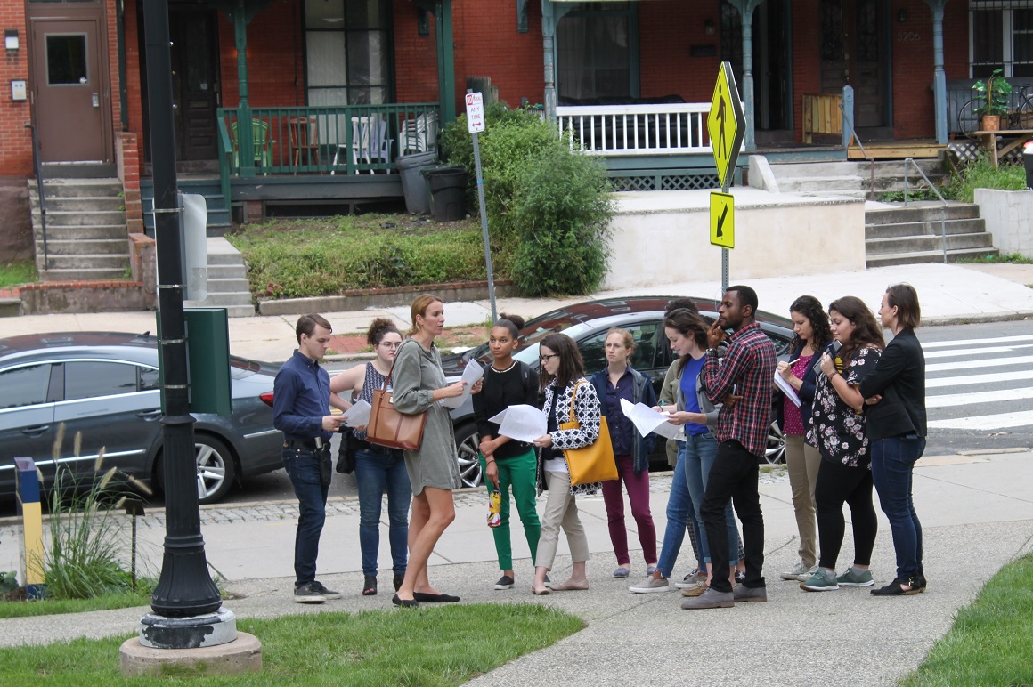 Students in park listening to speaker